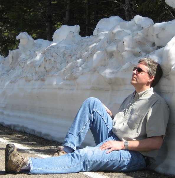 Eric Eide leaning against snow wall Eric Eide leaning against snow wall Eric Eide sitting on a road and leaning against a tall wall of snow. Eric Eide sitting on a road and leaning against a tall wall of snow.